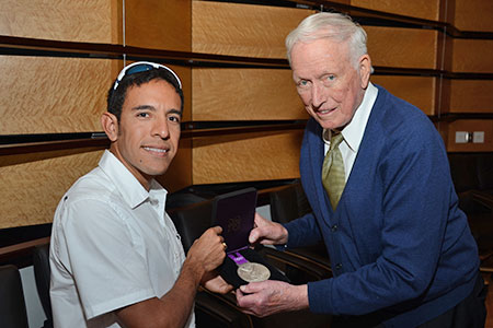 Olympian Leo Manzano and Dr. Denton Cooley hold Leo's silver medal