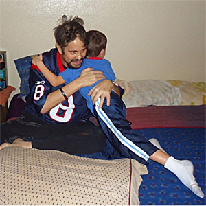 SynCardia Total Artificial Heart recipient Jeremiah Kliesing hugs his 6-year-old son John