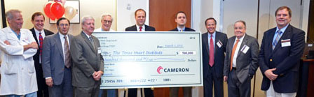 Cameron's engineering team presents a check for $500,000 to Texas Heart Institute. 