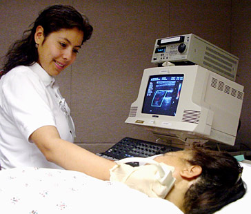 Photo of a technician conducting a doppler ultrasound study.